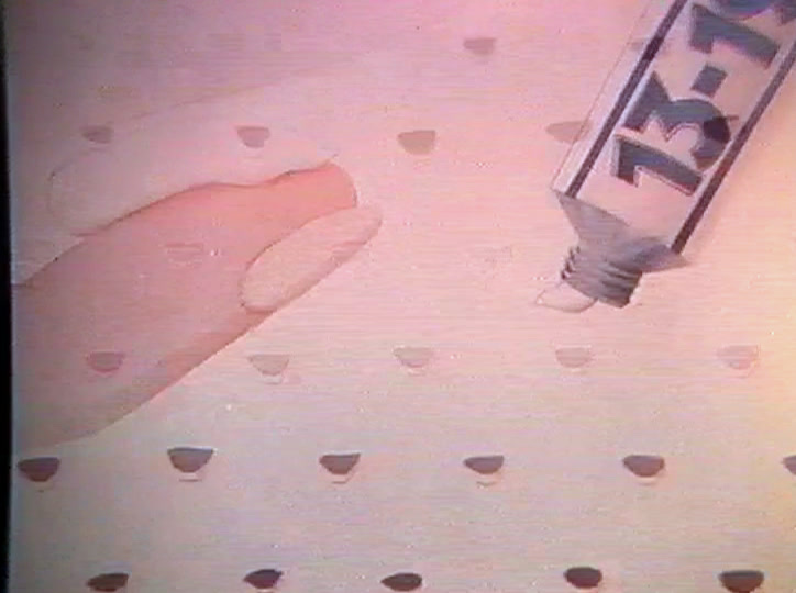A blue 13-19 tube squeezes a bead of cream onto a fingertip.