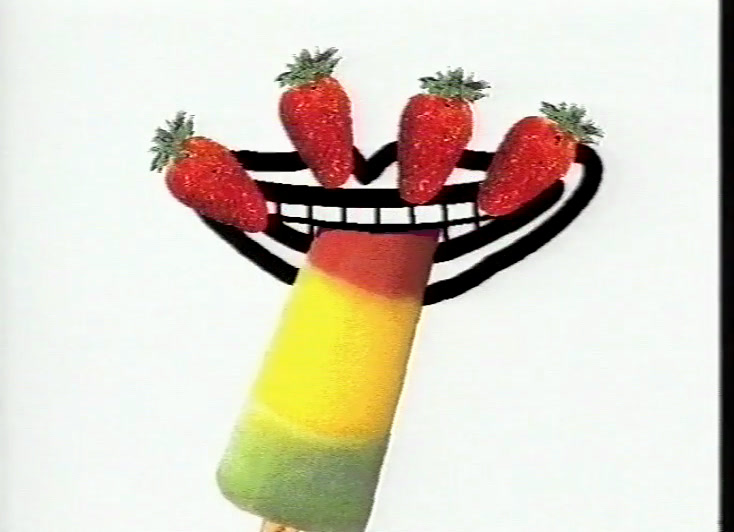 A brown, white and yellow ice lolly held beside a drawn open mouth on white.