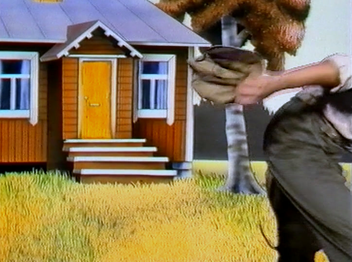 A man carrying a sack strides away from a small yellow wooden house and a birch tree.