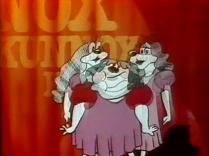 The chorus of dogs kicks together, one in a red dress stepping forward.