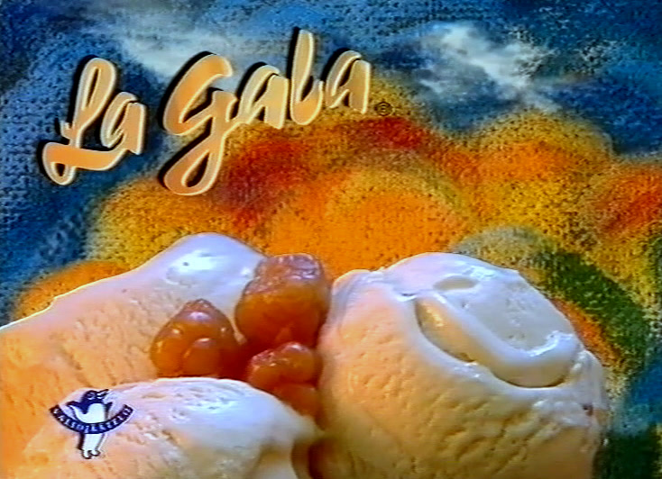 Close-up of a scoop and orange berries, script logotype above, Valio penguin below