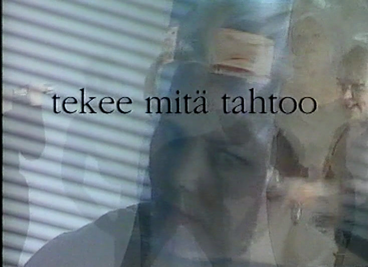 Blonde woman laughing in front of a slatted blind under the caption tekee mitä tahtoo