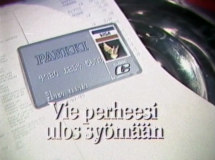 A Visa card on a printed bill beside a silver dish, end line beneath it.