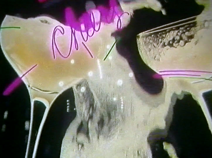 Drink spills between two glasses under a word written in pink neon.