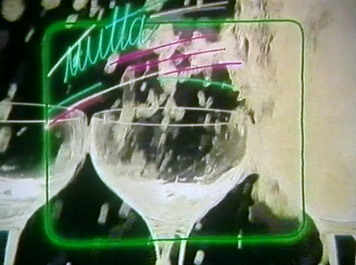 A splash bursts from a filled glass against black, green neon frame around it.