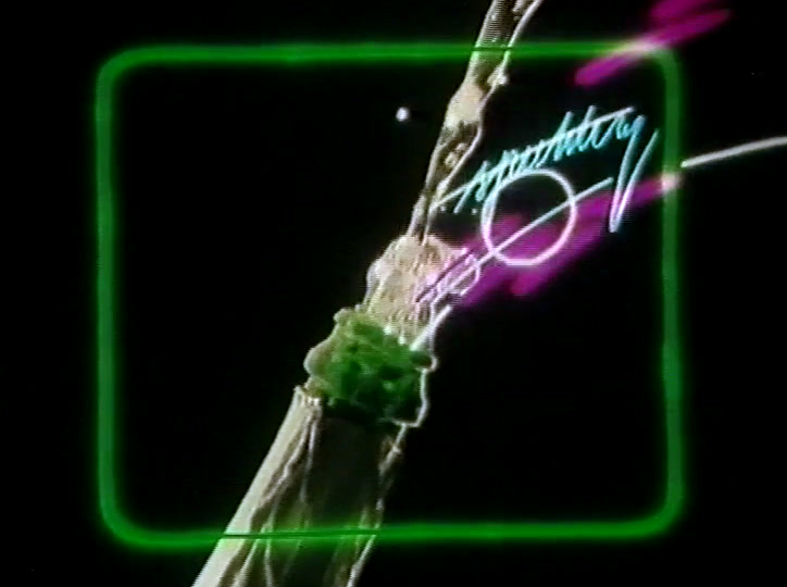 Two glasses of pale cider clash, drink flying, inside a green neon rectangle.
