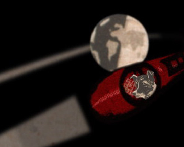 A pale globe floats in darkness above a red band with a metal dog's head badge.