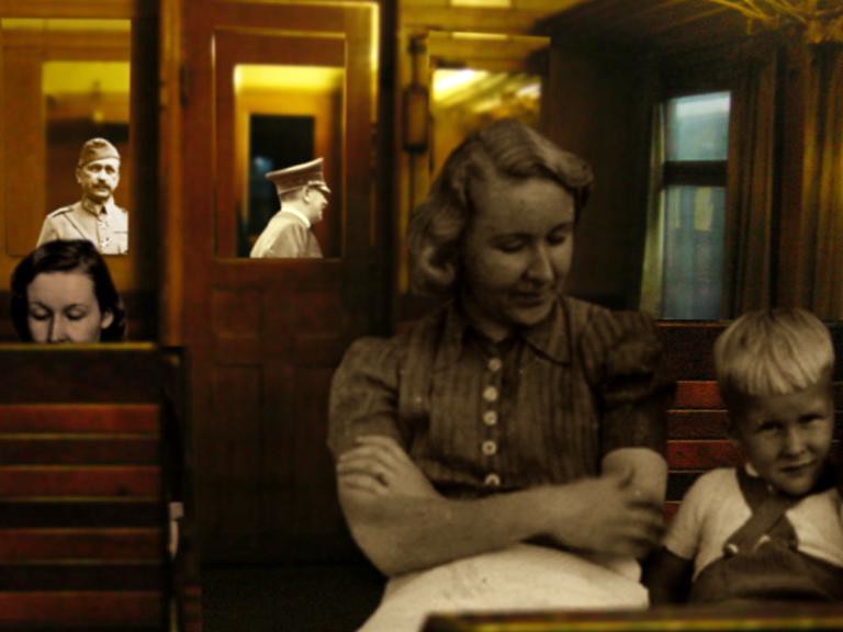 In a railway carriage a woman sits with a small boy, uniformed men framed in doorways behind.